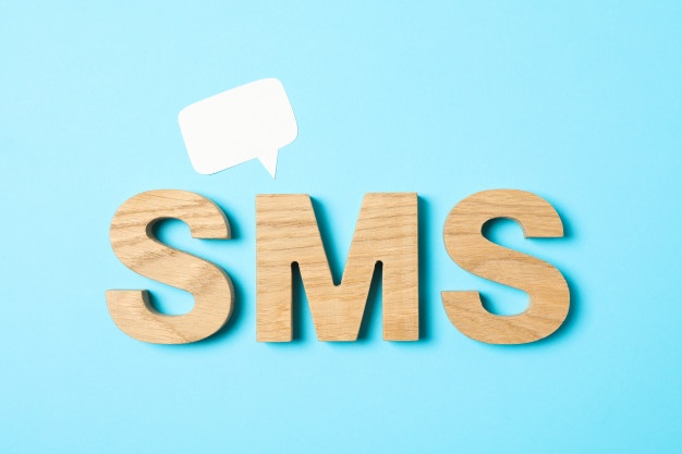 sms-word-made-from-wooden-letters-on-blue-background_185193-98